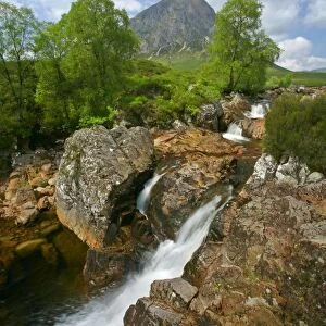 Mountain scenery Buachaille Etive Mor and waterfalls of Coupal river at low water level with red rocks and boulders visible Glen Etive, Glencoe area, Highlands, Scotland, UK
