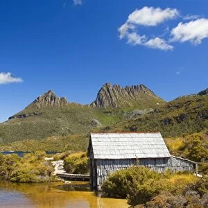 Mountain scenery - stunning Dove Lake in front of massive Cradle Mountain is one of Tasmania's most beautiful and famous natural features. A rustic boat shed gives a romantic touch - Cradle Mountain-Lake St