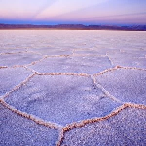 Salinas Grandes del Noroeste - mountains and dried-up salt lake showing a regular polygonal pattern created by salt crystals - at dusk - the salinas are located on an altitude of 3450 m above sea level on the so-called Altiplano - Prov