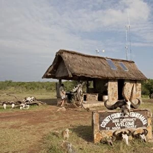 Solar PV Panels & Wind Turbine - on thatched roof game reserve entrance - Masai Mara - Kenya