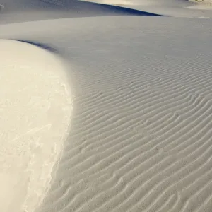 USA - The glistening dunes of White Sands in the Tularosa Basin are not sand, but fine gypsum, deposited on an ancient seabed 250 million years ago. Gypsum, a form of calcium sulfate, is water soluble and washes away USA - The glistening dunes of White Sands in the Tularosa Basin are not sand, but fine gypsum, deposited on an ancient seabed 250 million years ago. Gypsum, a form of calcium sulfate, is water soluble and washes away