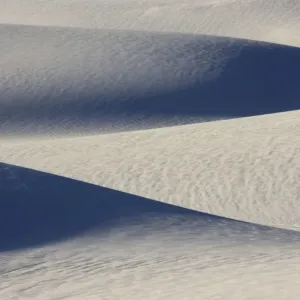 USA - The glistening dunes of White Sands in the Tularosa Basin are not sand, but fine gypsum, deposited on an ancient seabed 250 million years ago. Gypsum, a form of calcium sulfate, is water soluble and washes away USA - The glistening dunes of White Sands in the Tularosa Basin are not sand, but fine gypsum, deposited on an ancient seabed 250 million years ago. Gypsum, a form of calcium sulfate, is water soluble and washes away