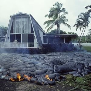 USA - Hawaii - Big Island - Eruption of the Pu'u O'o Vent - a vent of the Kilauea Volcano - Advancing lava flow surrounds a house in the village of Kalapana Gardens on the south shore of the island