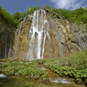 Waterfall cascading down steep cliffs in lower canyon area Plitvice Lakes National Park, Croatia