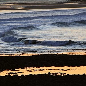 Waves-rolling on to beach at twilight, Northumberland UK