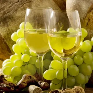Wine Glasses - with white wine and grapes Wine Glasses - with white wine and grapes