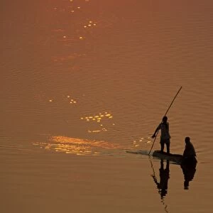 Zambia - Fishermen at sunset on the Luangwa river. South Luangwa National Park, Zambia