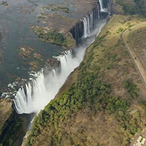 Zimbabwe / Zambia - Aerial view of the Zambezi River and the Victoria Falls (1700m wide). In the foreground the Main Falls (93m high, Zimbabwe), in the centre Livingstone Island (borderline Zimbabwe/Zambia), behind the Rainbow Falls (108m)