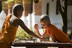 Board Gallery: 2 young Buddhist novices playing a board game in