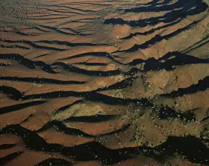 Aerial: south-western side of Hamersley Range the Pilbara seabed rose to form one of Earth's first permanent land masses about 3. 5 billion years ago. The area shown is rich in iron oxides, Pilbara region, Western Australia JPF44350