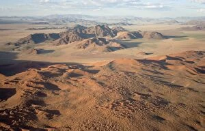 Aerial view of grass-grown sand dunes and isolated