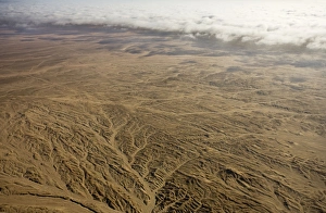 Aerial view of mist rolling in from the cold Atlantic Ocean over the Namib Desert Plains Aerial view of mist rolling in from the cold Atlantic Ocean over the Namib Desert Plains