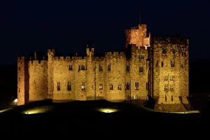 Castle Collection: Alnwick Castle-illuminated at night-time, Northumberland UK