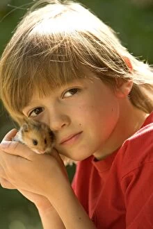 Images Dated 25th June 2005: Angora Hamster - being held by child