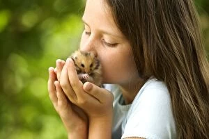 Images Dated 25th June 2005: Angora Hamster - being held by girl