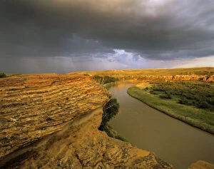 Badland Gallery: Approaching storm on the Milk River at Writing
