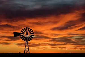 Orange Prints: Argentina, Province Chubut, Patagonia Windmill on the Patagonian steppe at sunset