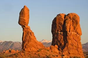 Balanced rock - sandstone rock formation in the shape of a spire with an oval shaped rock balanching on top of it
