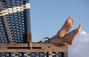 Bare Gallery: Bare Feet resting on wicker beach chair