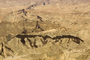 Dolerite Gallery: Black dolerite dykes clearly visible as they cut through the rocky terrain of the Moon Valley near