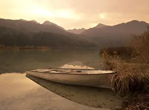 Romantic Prints: Boat at lake in the bavarian mountains in autumn Weissensee, Bavaria, Germany