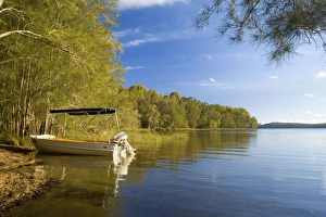 Images Dated 9th October 2008: Boating idyll - small motorboat anchors in a tranquil bay at the Myall Lakes