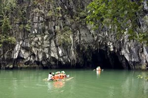 Boats with tourists enter the cave, that features