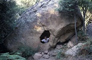 Boys Gallery: Boy looking through hole in Rock formation