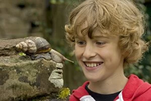 Images Dated 15th August 2007: Boy Observing Giant African Land Snail