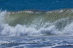 Breaking wave rolling ashore