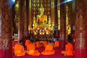 Buddhist monks at worship in Wat Sen temple in Luang Pra