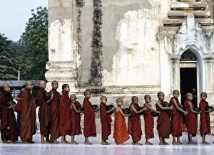 Burma Gallery: Buddhist Monks young monks queuing with alms bowls of food