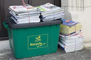 Recycling Prints: Bundles of magazines and newspapers neatly tied and left for recycling on green bin Cotswolds UK