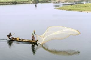 Burmese Fishermen throwing a fishing net