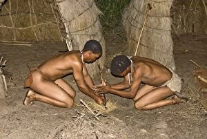 Bushmen Gallery: Bushman - lighting a fire by traditional method