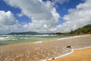 Cable Bay waves rolling in on the golden beach of Cable Bay before a thunderstorm Cable Bay, Doubtless Bay, Northland, North Island, New Zealand