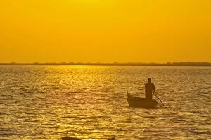 Images Dated 17th October 2007: Camargue fisherman going out at dawn to see to his nets