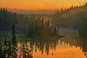 Mike Prints: Canada, Ontario, Schreiber. Sunrise fog and forest reflect in lake. Date: 19-07-2008