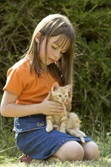 Cat - girl holding ginger kitten