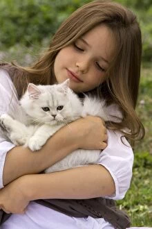 Cat - kitten being held by young girl