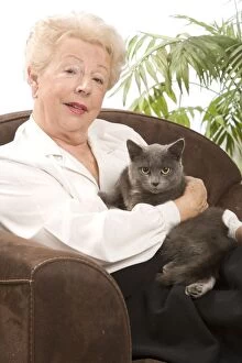 Cat - woman cuddling grey cat