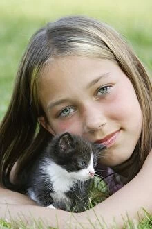 Cat - young black & white kitten with girl