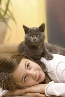Cat - Young girl lying on floor with grey cat lying