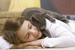 Images Dated 29th January 2007: Cat - Young girl lying on floor with grey cat sleeping