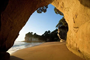 Rocks Gallery: Cathedral Cove - beach at Cathedral Cove seen through a natural rock arch in early morning light