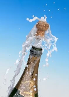 Champagne cork shooting out of the bottle