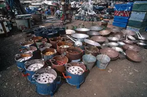 Selling Prints: Charcoal cooking stoves in downtown market Nairobi Kenya
