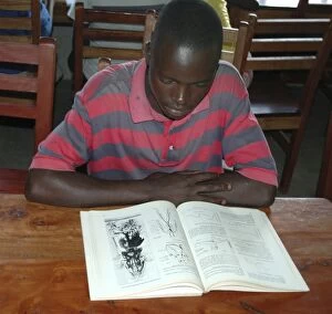 Child at Equatorial College School - reading book