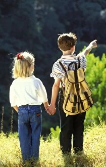 Children - backview of boy and girl holding hands