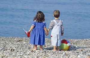 Boys Gallery: Children - boy & girl holding hands on beach Children - boy & girl holding hands on beach